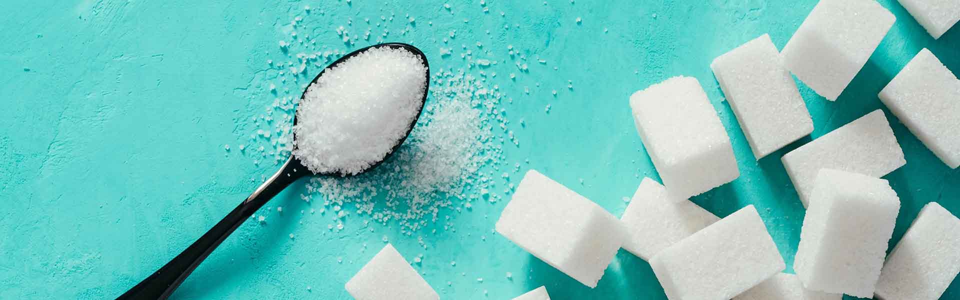 Spoon full of sugar and sugar cubes