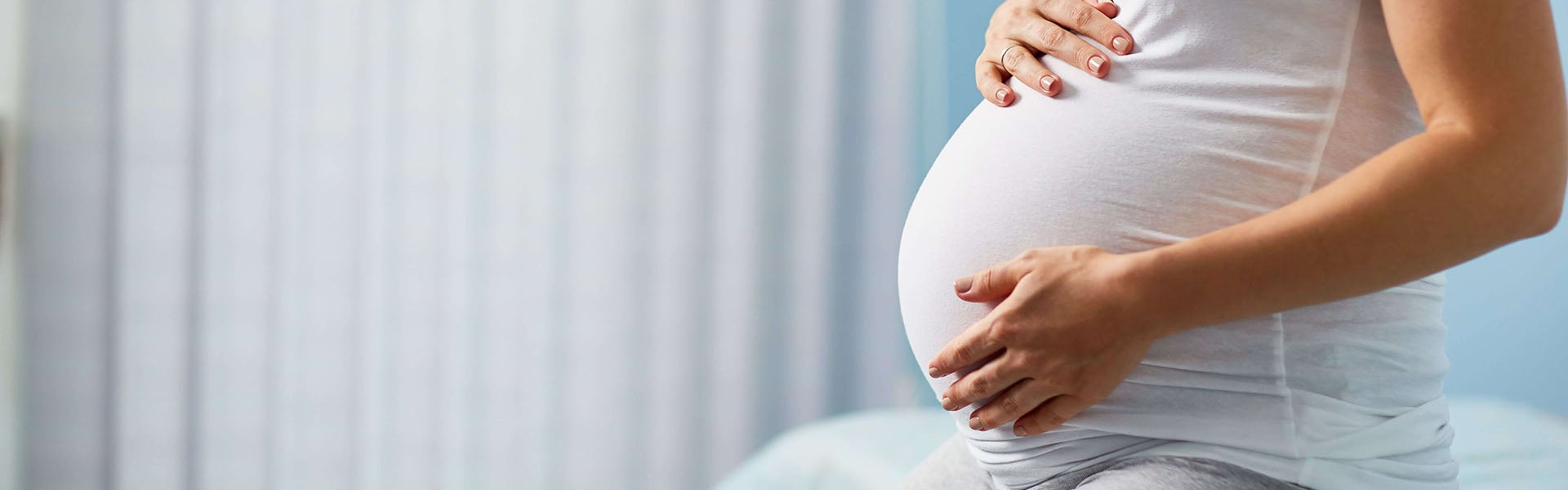 Pregnant woman holding stomach
