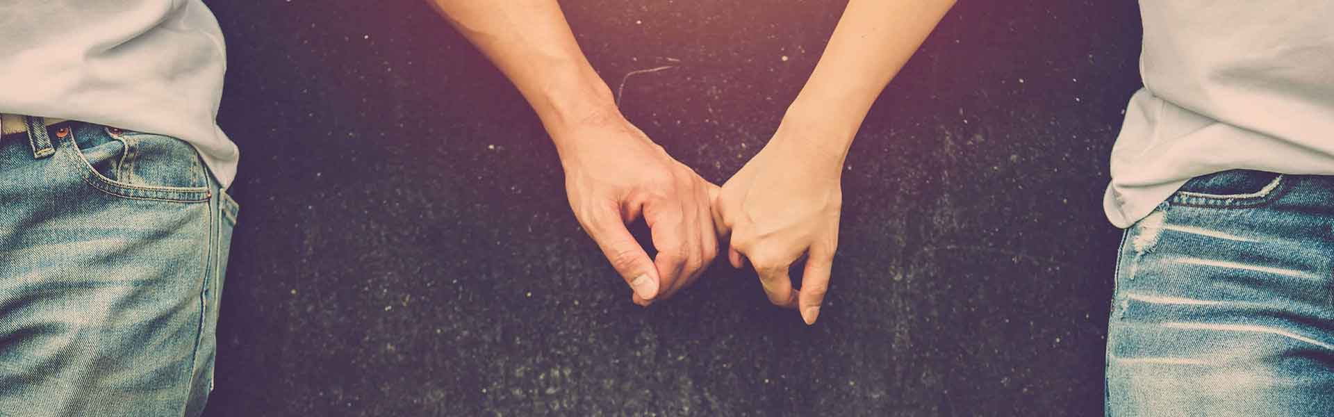 Two people holding hands