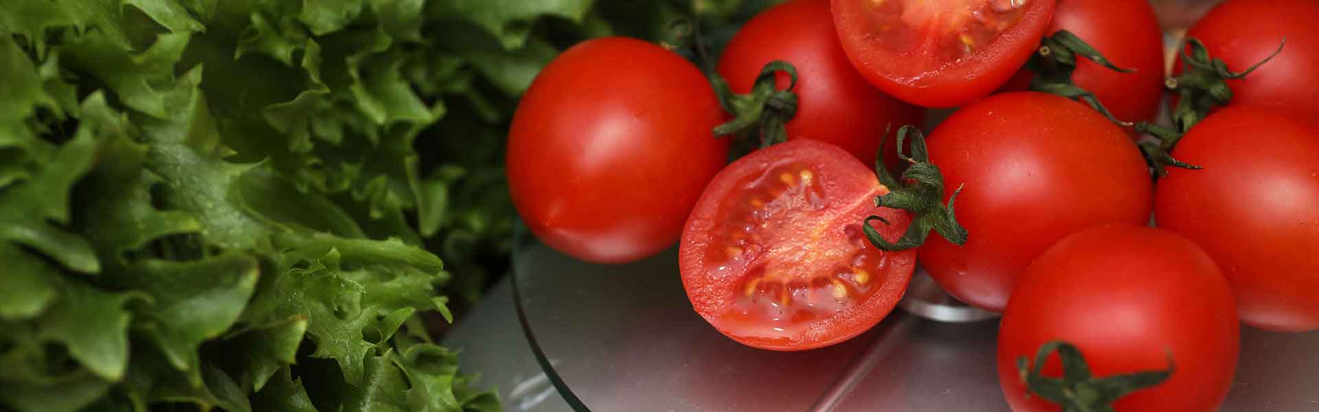 Tomatoes and lettuce being weighed