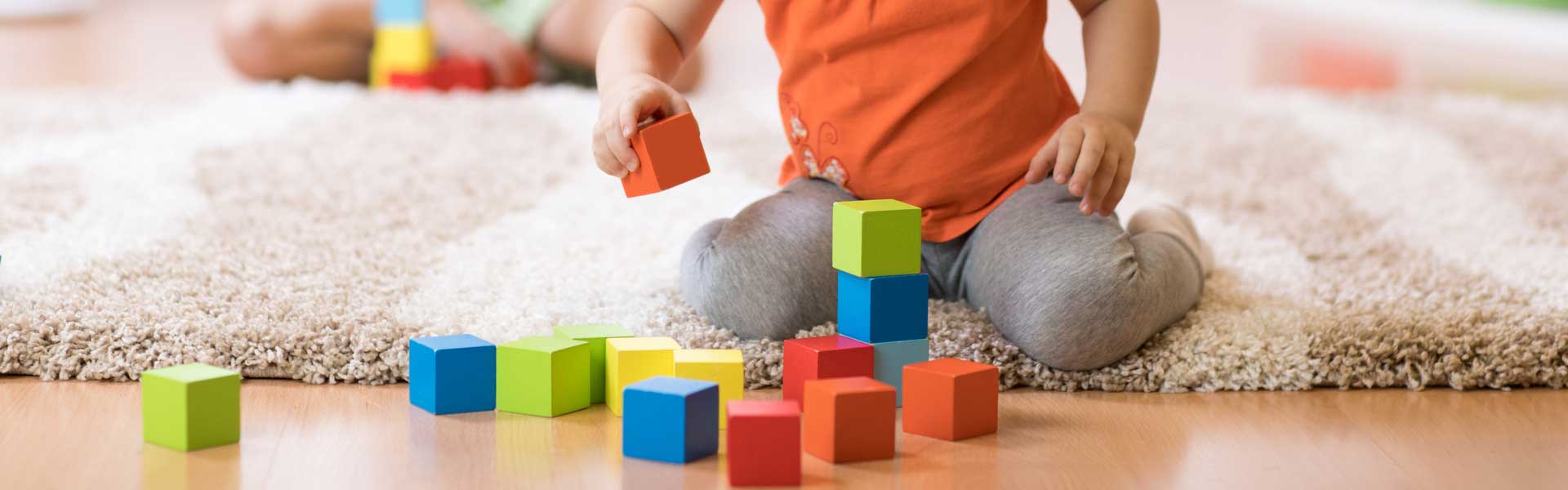 Child playing with bright blocks