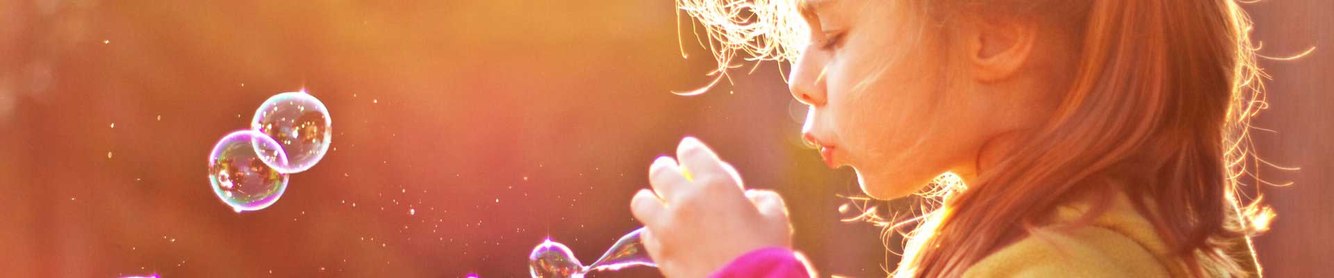 Little girl blowing bubbles