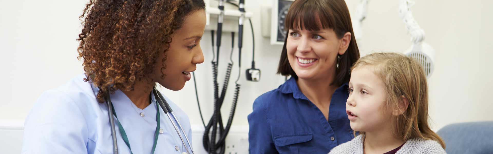Mother and child talking to healthcare professional