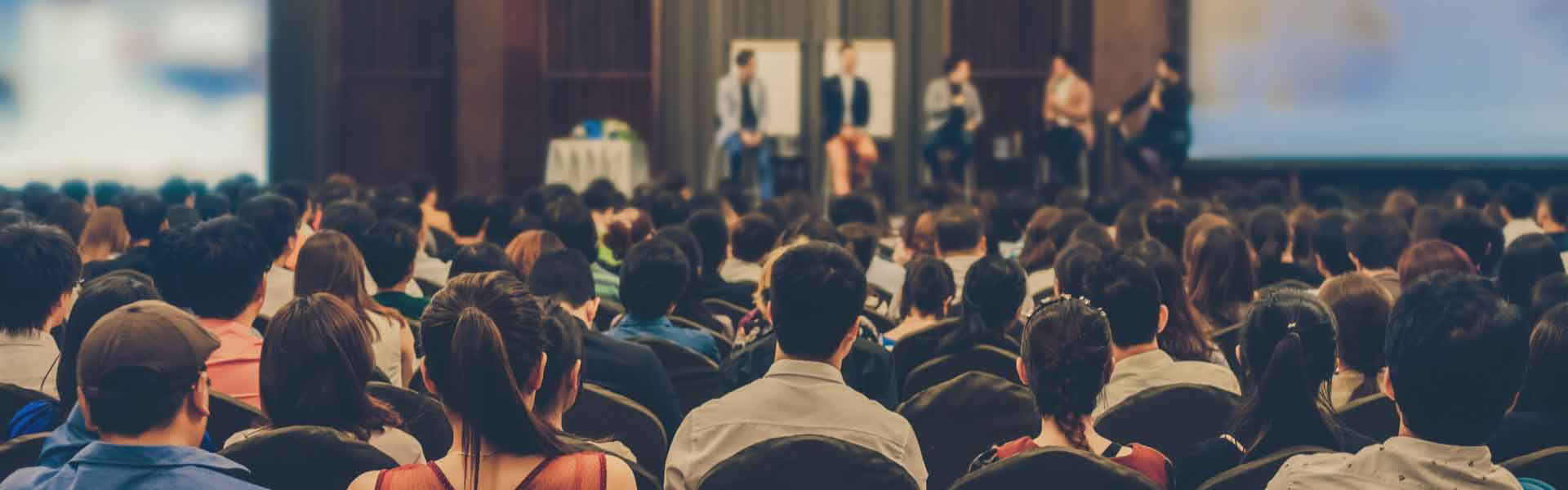 Audience watching speakers on a stage
