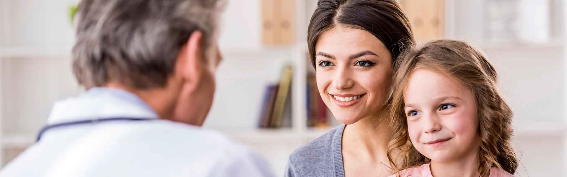 Mother and daughter talking to healthcare professional