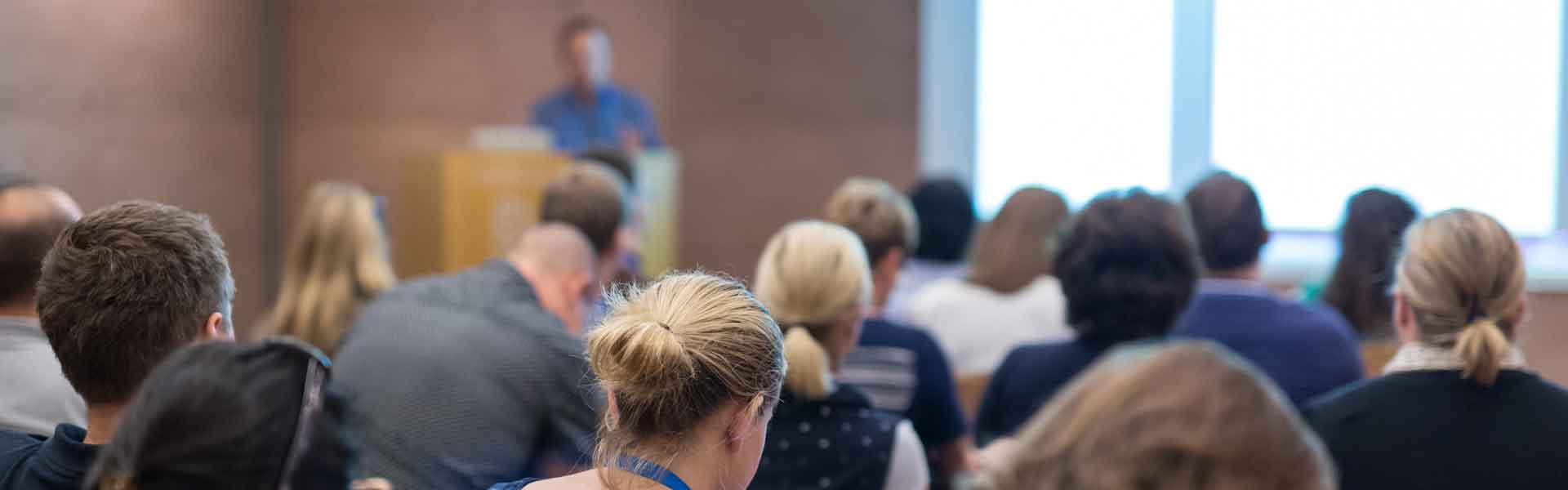 Speaker presenting to a room of delegates
