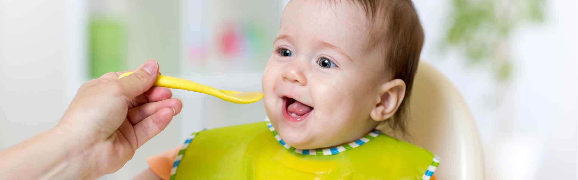 Toddler being fed with a spoon