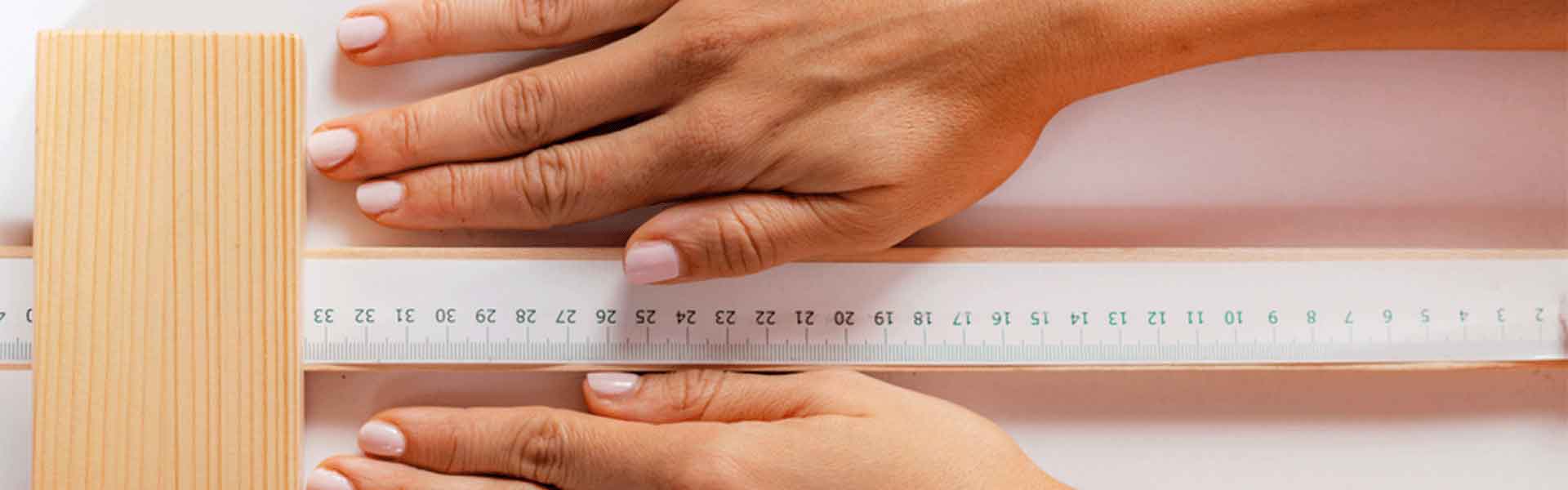 women's hands holding a ruler