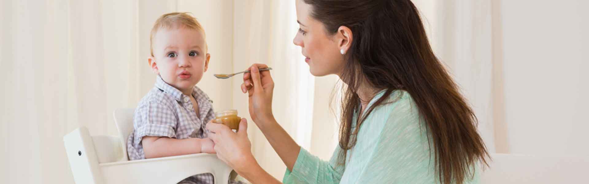 mother feeding an infant 