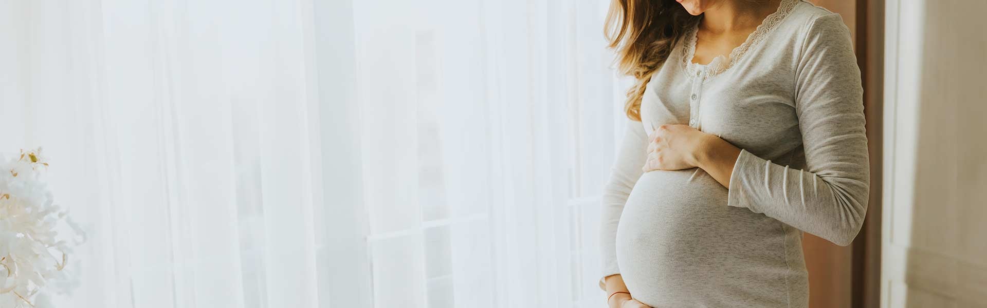 woman holding her baby bump