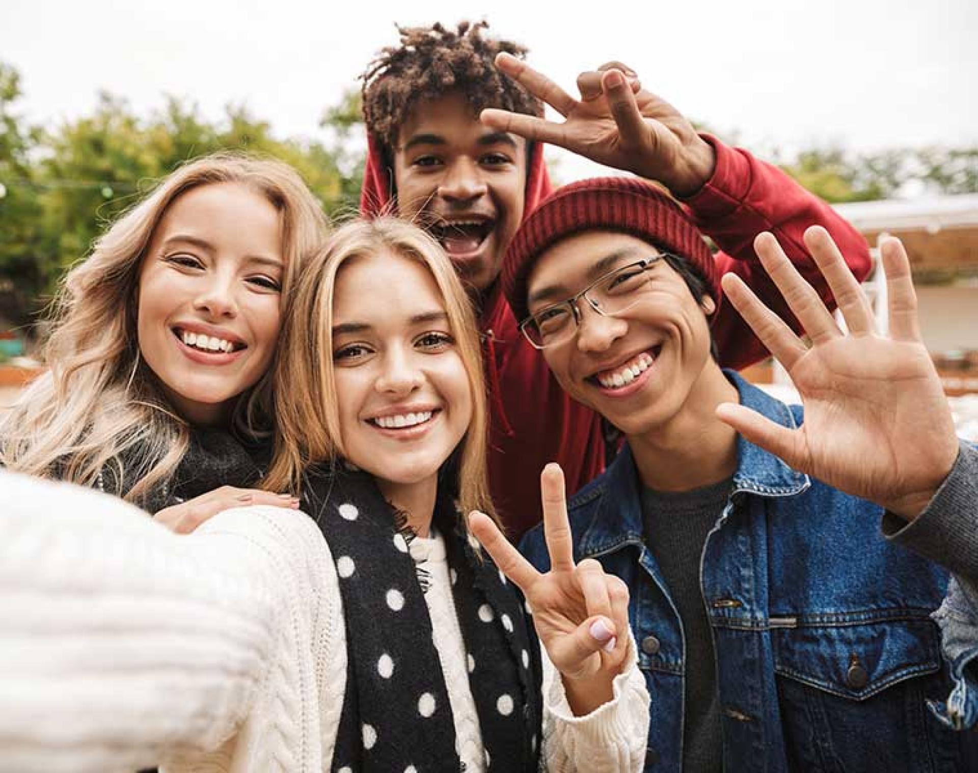 Group of four young people taking a selfie