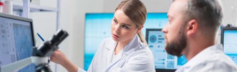 two researchers looking at data