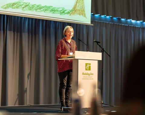 Dr. Charlotte Harris speaking on a stage