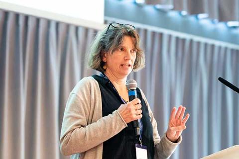 Alexandra Jung speaking on stage